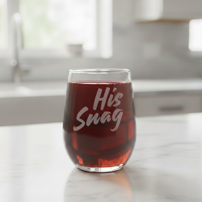 Gemini said
"His Snag" 20.5oz etched stemless wine glass by Expressive DeZien, filled with a red liquid, on a white marble kitchen countertop.