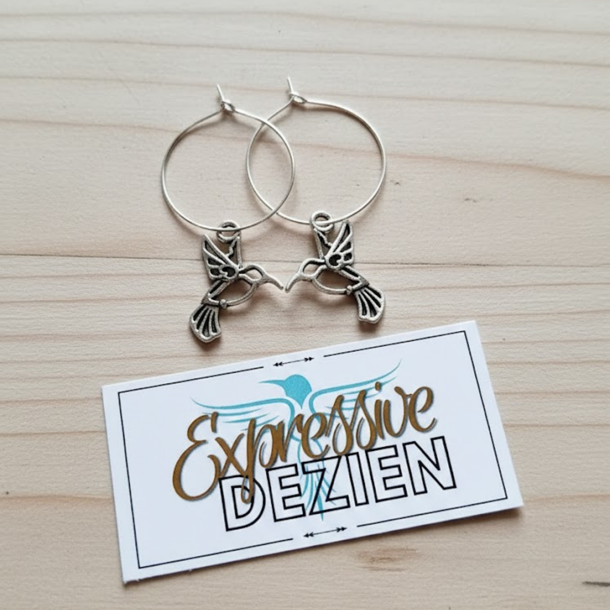 Signature Silver Hummingbird Hoop Earrings by Expressive DeZien included with "Her Snag" wine glass sets