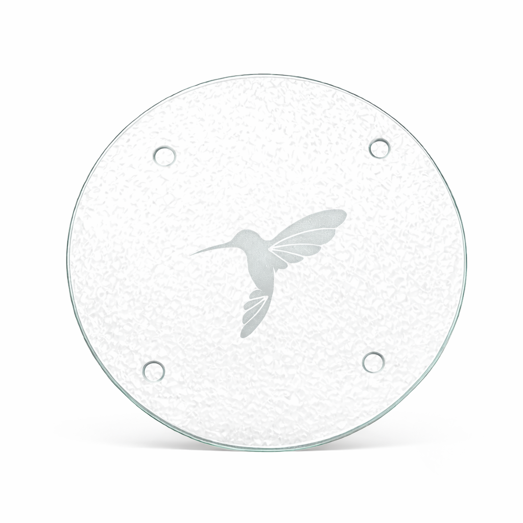 Round glass trivate with a hummingbird design on a white background