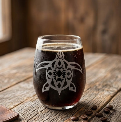 Tribal Turtle sandblasted stemless wine glass on a natural wood table