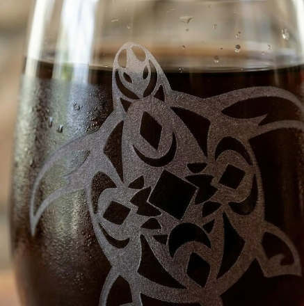 Macro closeup of deep sandblasted Tribal Turtle etching on stemless wine glass